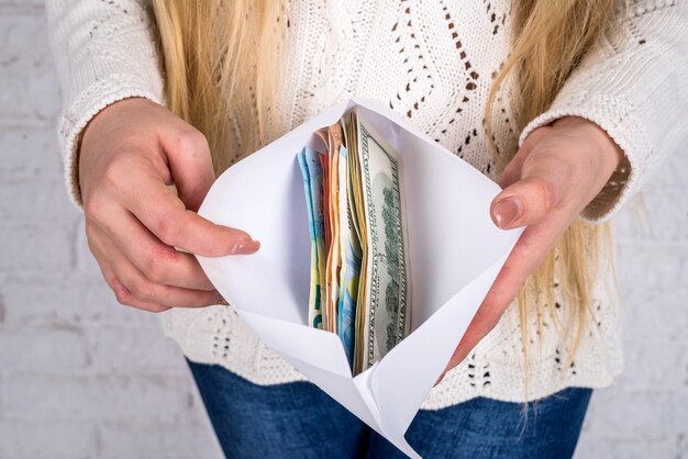 A person putting cash into different labeled envelopes: 