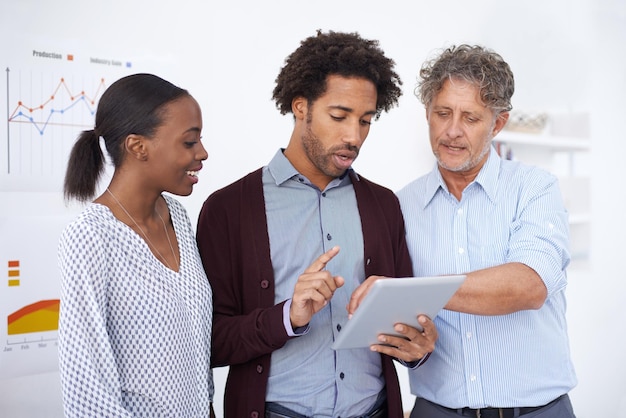 A diverse group of employees looking at a customized benefits dashboard on a tablet, with options for health, wellness, and financial planning. Each person is smiling and appears engaged with their choices.