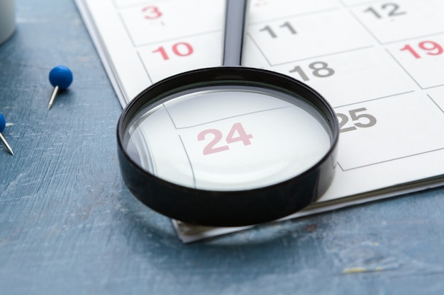 A calendar highlighting the open enrollment period, with a magnifying glass focusing on the dates. The image symbolizes the importance of paying attention to the specific timeframe for enrollment.
