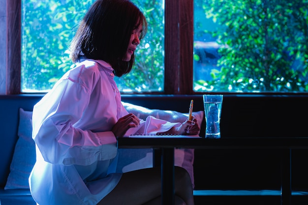 A person working on a futuristic holographic workstation at home highlighting the use of technology in remote work.