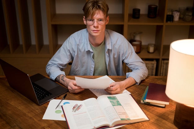 A person sitting at a desk, using a calculator and reviewing a stack of papers related to employee benefits. The scene is focused on the financial analysis aspect of calculating the true cost.
