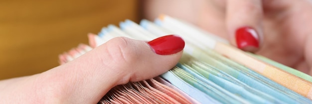 A close-up shot of a landlord's hands meticulously organizing receipts and financial documents related to their rental property. The focus is on the detailed record-keeping and financial management required for effective tax deductions.