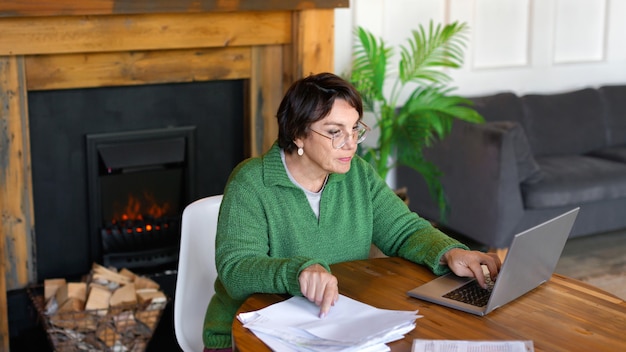 A landlord reviewing a detailed spreadsheet on a laptop, showing rental income, expenses, and tax deductions. The scene emphasizes the use of technology and meticulous record keeping for effective financial management and tax planning.
