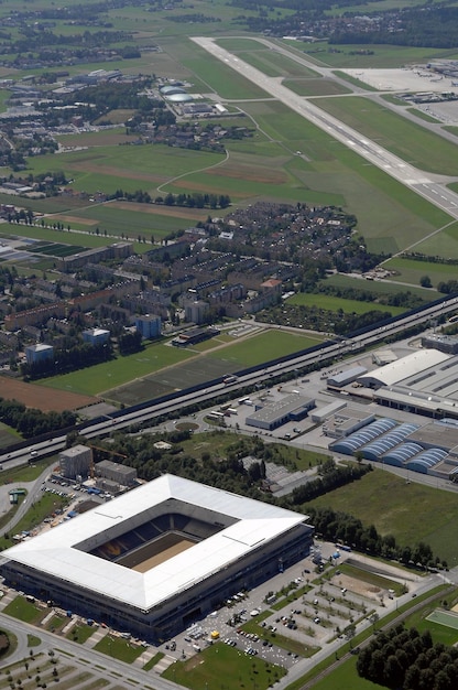 An aerial shot of a modern solar panel manufacturing facility in the United States, showing robots assembling the panels and workers overseeing the production process. The facility is brightly lit and clean, symbolizing the advanced technology and efficiency of the industry.