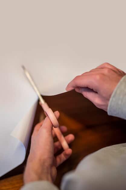 A close-up shot of a hand signing a will with a pen, with legal documents and a gavel in the background, emphasizing the importance of legal precision in estate planning.