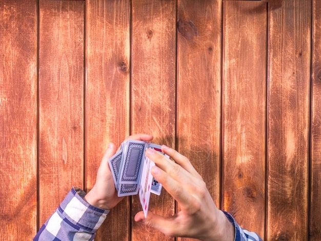 A hand holding a stack of dollar bills, with a credit card resting on top. The scene is brightly lit to symbolize financial gain and rewards.