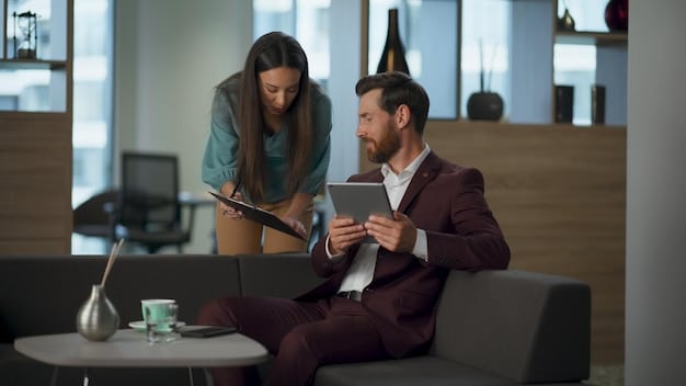 A financial advisor is meeting with an employee in a relaxed office setting. They are reviewing retirement plan options on a tablet, and the employee is smiling confidently as they discuss their financial goals.