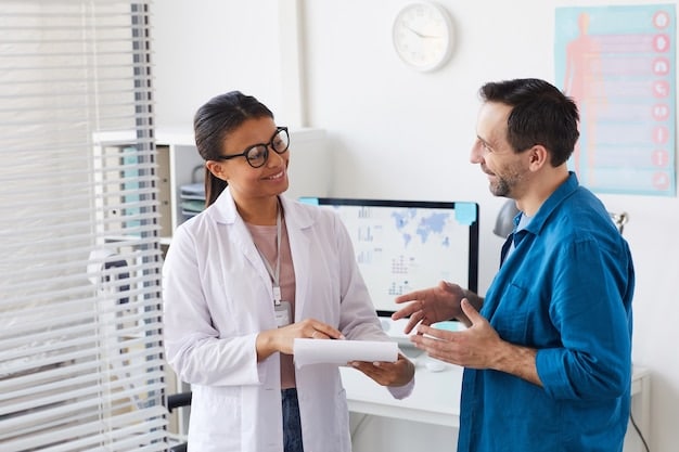 A doctor discussing health results with an employee, both smiling and looking at a chart. The setting is a modern clinic, and the image emphasizes preventive healthcare and a positive health relationship.