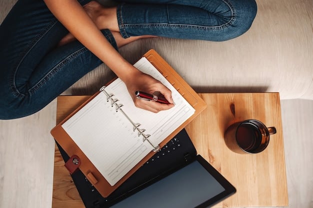 A person sitting at a desk, holding a pen and paper, and thoughtfully writing down a list of their benefits priorities.