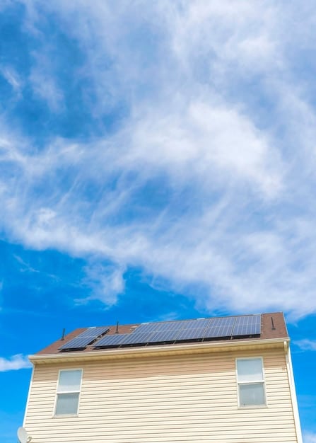 Solar panels installed on a residential rooftop during a sunny day, with a clear blue sky in the background. It illustrates the use of renewable energy and energy efficiency in a home