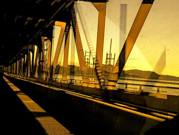 A construction site with workers building a modern bridge, symbolizing infrastructure investment and economic development.