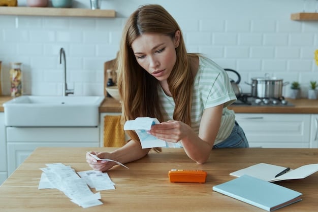 A person using a calculator and looking at a tax document, with a pile of tax-related papers nearby, symbolizing the process of calculating the Child Tax Credit and preparing taxes.