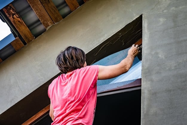 An installer placing a layer of pink fiberglass insulation within the attic. The image shows the process of upgrading home insulation to improve energy efficiency.