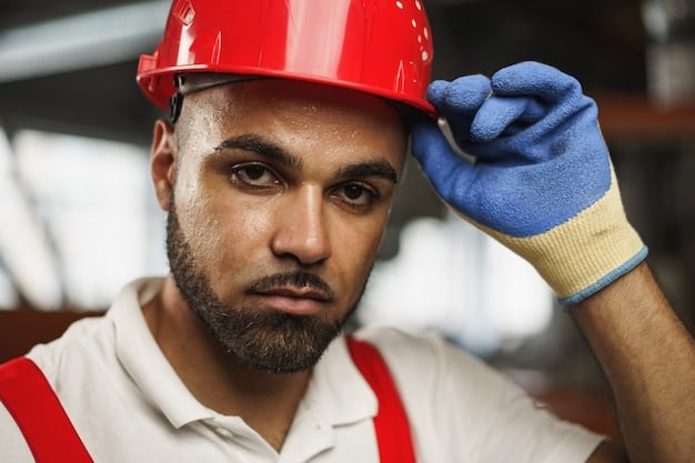 A close-up shot of a worker wearing a hard hat and safety vest, holding a tablet and inspecting a newly installed fiber optic cable. The background features a rural landscape with houses and trees, symbolizing expanded internet access in underserved areas.